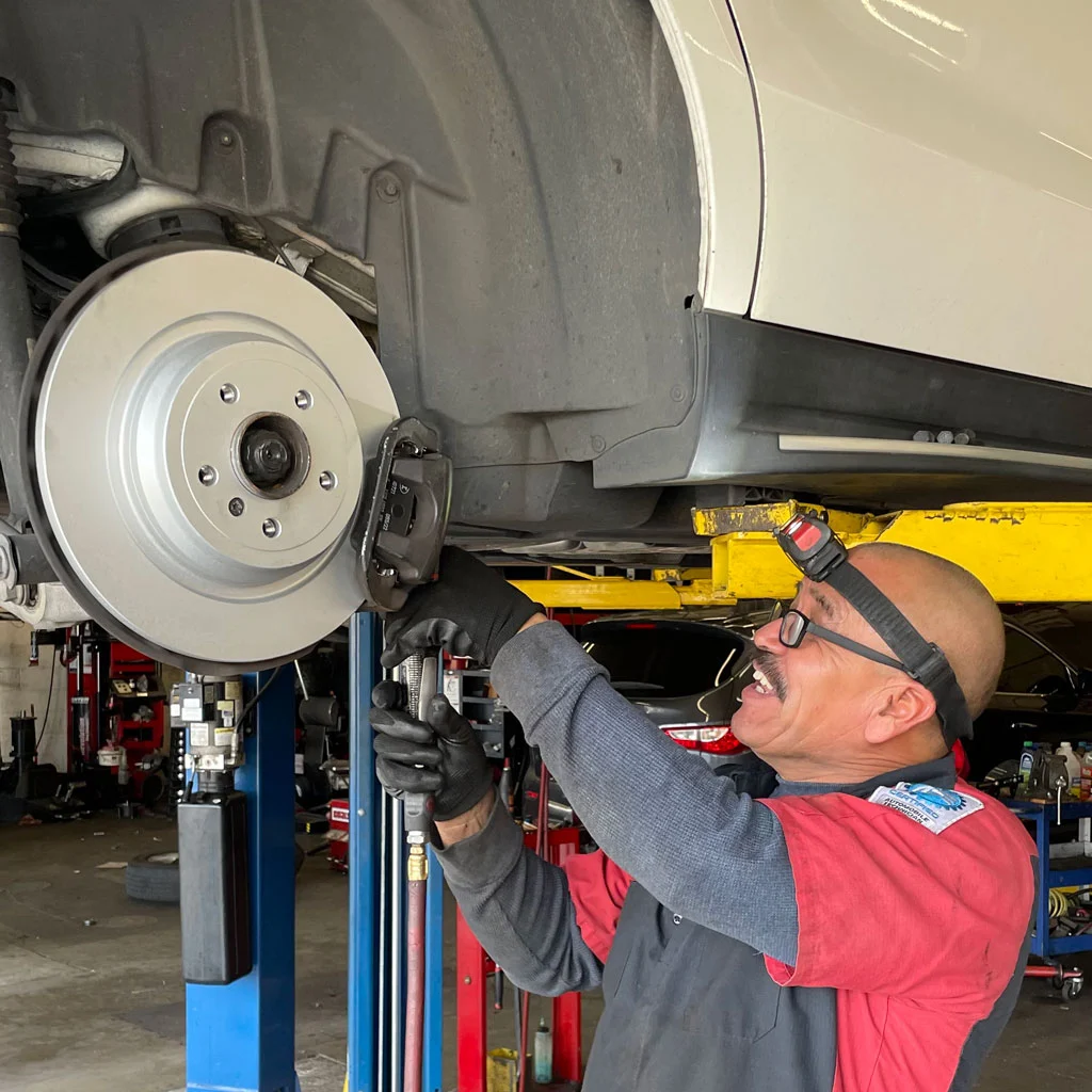 Mechanic Performing A Brake Repair On A Mercedes Benz