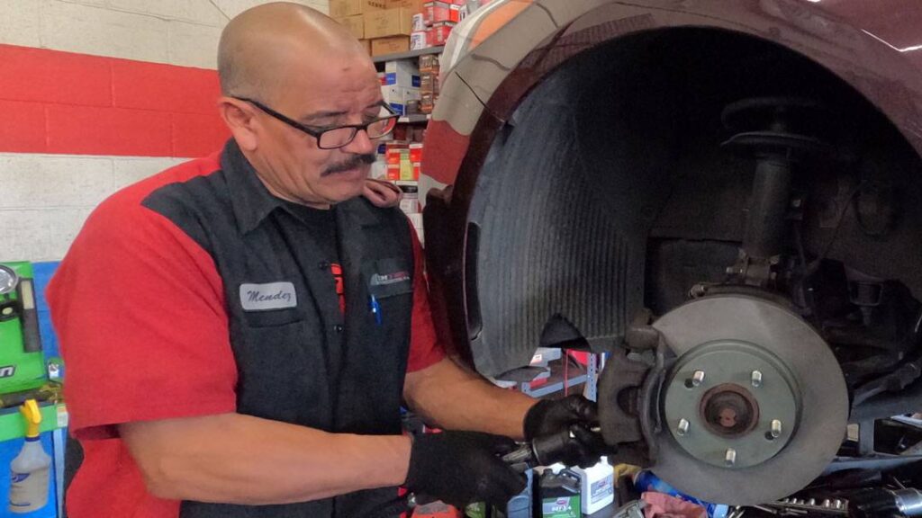 Technician performing a brake job