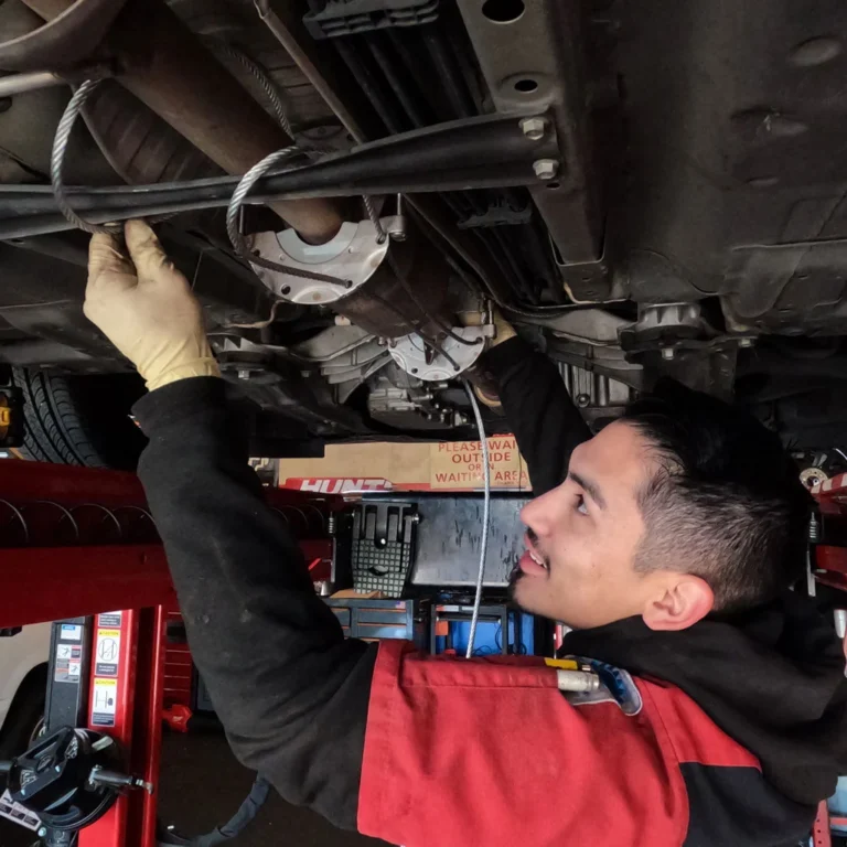 Mechanic Installing a Catalytic Converter Theft Deterrent